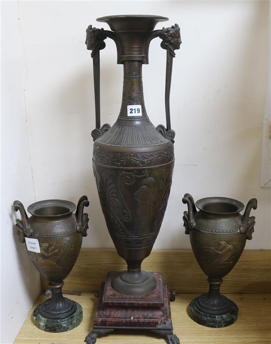 A large bronzed spelter urn and a pair of similar smaller urns tallest 70cm